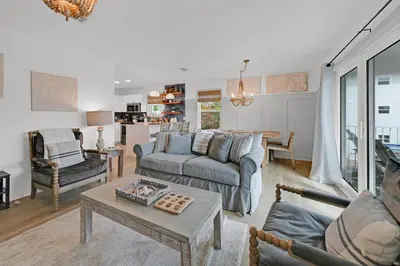 a living room with a couch and a table at Beachside Villas 1123- A Sandy Carol in Santa Rosa Beach
