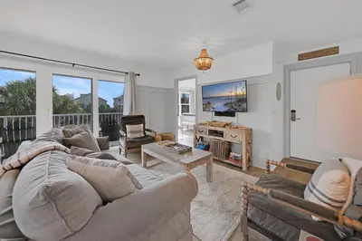 a living room with a couch and a table at Beachside Villas 1123- A Sandy Carol in Santa Rosa Beach