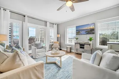 a living room with white furniture and windows at Cassine Way 301 – 30A Blue Sky Breeze in Santa Rosa Beach