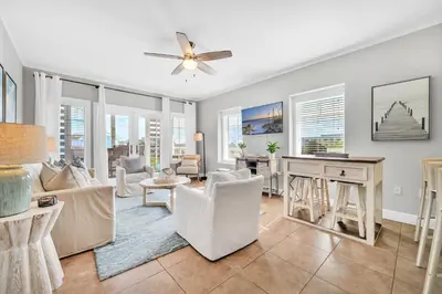 a living room with white furniture and a ceiling fan at Cassine Way 301 – 30A Blue Sky Breeze in Santa Rosa Beach