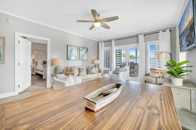 a living room with a table and a couch at Cassine Way 301 – 30A Blue Sky Breeze in Santa Rosa Beach