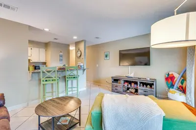 a living room with a couch and a kitchen at Panama City Beach Condo with Pool and Beach Access! in Panama City Beach