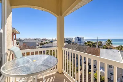a balcony with a table and a view of the ocean at Casa Del Mar in Panama City Beach