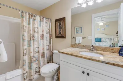 a bathroom with a toilet and a sink and a shower at Casa Del Mar in Panama City Beach