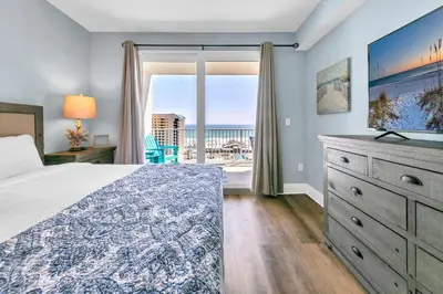 a bedroom with a bed and a view of the ocean at Laketown Wharf 827 - Lifes A Beach by Emerald Coast Retreats in Panama City Beach