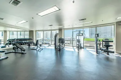 a gym with treadmills and machines in a building at Laketown Wharf 827 - Lifes A Beach by Emerald Coast Retreats in Panama City Beach