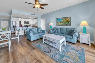 a living room with a couch and a dining room at Laketown Wharf 827 - Lifes A Beach by Emerald Coast Retreats in Panama City Beach