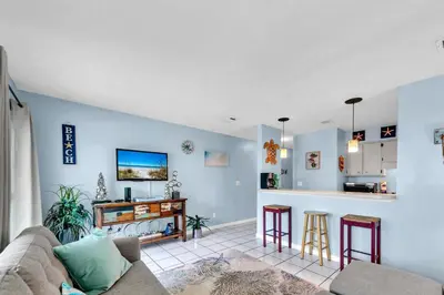 a living room with a couch and a table at Nautical Watch E-3 in Panama City Beach