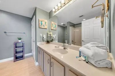 a bathroom with a sink and a mirror at Sterling Reef 1504 in Panama City Beach