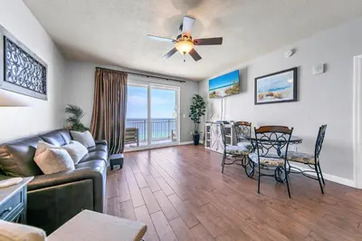 a living room with a couch and a table at Sterling Reef 1504 in Panama City Beach