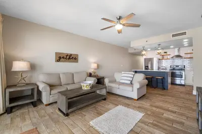 a living room with a couch and a table at Laketown Wharf #1411 by Nautical Properties in Panama City Beach