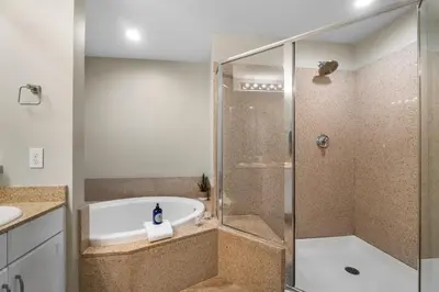 a bathroom with a shower and a bath tub at Laketown Wharf #1411 by Nautical Properties in Panama City Beach