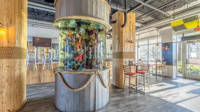 a large wooden exhibit in a room with tables and chairs at Laketown Wharf #1411 by Nautical Properties in Panama City Beach