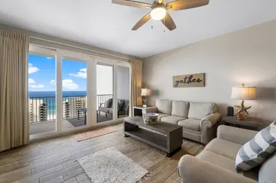 a living room with a couch and a ceiling fan at Laketown Wharf #1411 by Nautical Properties in Panama City Beach