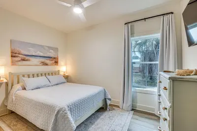 a bedroom with a bed and a window at Chic Panama City Beach Home, Walk to Laguna Beach! in Panama City Beach