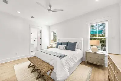 a white bedroom with a bed and a window at Southern Grove in Santa Rosa Beach