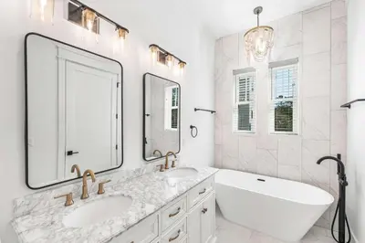 a bathroom with two sinks and a large mirror at Southern Grove in Santa Rosa Beach