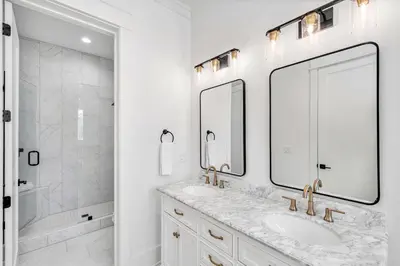 a white bathroom with a sink and a shower at Southern Grove in Santa Rosa Beach