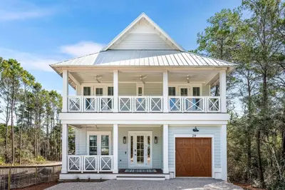 a white house with a gambrel roof at Southern Grove in Santa Rosa Beach