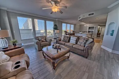 a living room with couches and a table at Modern Oceanfront Retreat, Spacious Balcony - 0207 condo in Panama City Beach