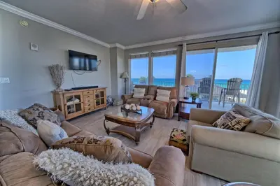 a living room with couches and a view of the ocean at Modern Oceanfront Retreat, Spacious Balcony - 0207 condo in Panama City Beach