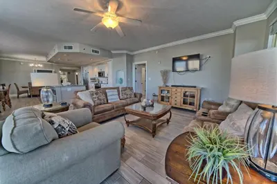 a living room with couches and a ceiling fan at Modern Oceanfront Retreat, Spacious Balcony - 0207 condo in Panama City Beach