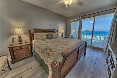 a bedroom with a bed and a view of the ocean at Modern Oceanfront Retreat, Spacious Balcony - 0207 condo in Panama City Beach