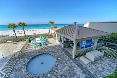 a house with a swimming pool next to the beach at Modern Oceanfront Retreat, Spacious Balcony - 0207 condo in Panama City Beach