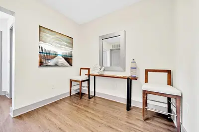 a room with a table and two chairs and a painting at The Pointe 1-134 in Inlet Beach