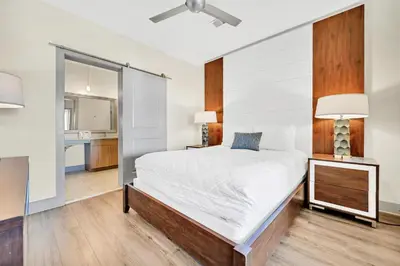 a bedroom with a large white bed and a mirror at The Pointe 1-134 in Inlet Beach
