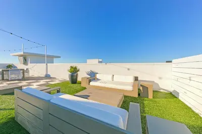 a garden with a bench and a couch on the grass at The Pointe 1-134 in Inlet Beach