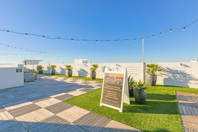 a sign in the grass next to a beach at The Pointe 1-134 in Inlet Beach