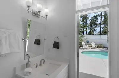 a bathroom with a tub and a sink and a pool at Hattie's Hideawy at Seacrest in Santa Rosa Beach