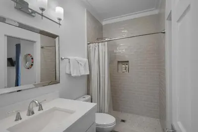 a white bathroom with a sink and a toilet at Hattie's Hideawy at Seacrest in Santa Rosa Beach