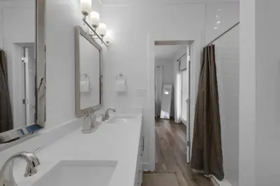 a white bathroom with two sinks and a mirror at Hattie's Hideawy at Seacrest in Santa Rosa Beach