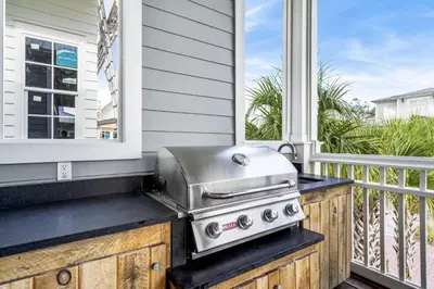 a grill on a porch with a window at Endless Summer Nights at Seacrest in Inlet Beach