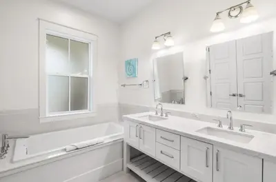 a white bathroom with two sinks and a large mirror at Endless Summer Nights at Seacrest in Inlet Beach