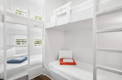 a white walk in closet with white shelves and a red folder at Endless Summer Nights at Seacrest in Inlet Beach
