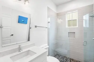 a white bathroom with a sink and a toilet at Endless Summer Nights at Seacrest in Inlet Beach