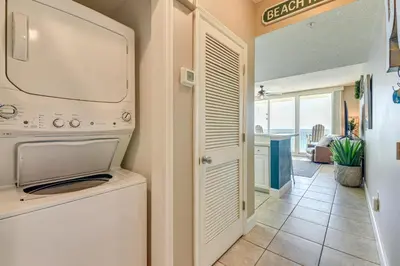 a laundry room with a washer and dryer at Walk to Shore Panama City Beach Condo with Pool in Panama City Beach