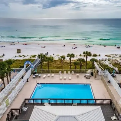 a view of a swimming pool and a beach at PCB Haven - 2 Bedroom/1.5 Bath Condo in Gulf Highlands in Panama City Beach