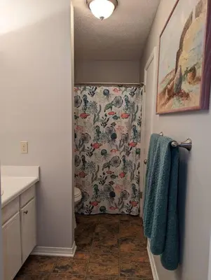 a bathroom with a shower with a shower curtain at PCB Haven - 2 Bedroom/1.5 Bath Condo in Gulf Highlands in Panama City Beach