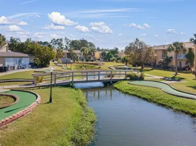 a bridge over a river in a park at PCB Haven - 2 Bedroom/1.5 Bath Condo in Gulf Highlands in Panama City Beach