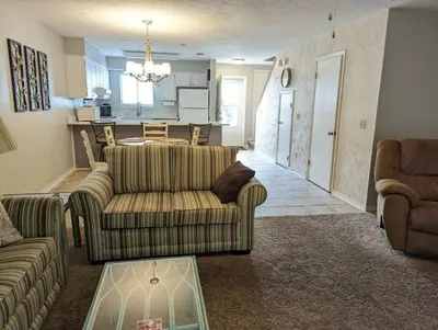 a living room with two couches and a kitchen at PCB Haven - 2 Bedroom/1.5 Bath Condo in Gulf Highlands in Panama City Beach