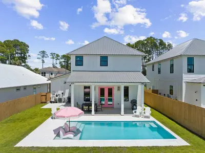 a house with a swimming pool in the yard at Shimmy By The Sea by 30A Escapes in Panama City Beach