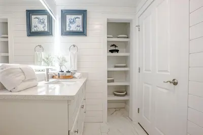 a white bathroom with a sink and a white door at Ocean Blue at 1805 Aqua in Panama City Beach