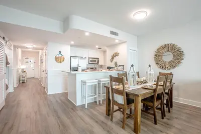 a kitchen and dining room with a table and chairs at Ocean Blue at 1805 Aqua in Panama City Beach