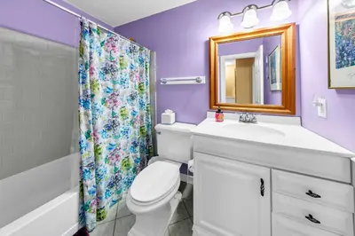 a bathroom with a toilet and a sink and a mirror at Cassine Gardens 189 in Santa Rosa Beach