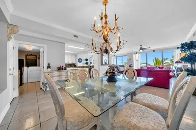 a dining room with a glass table and chairs at Hidden Dunes 203 in Panama City Beach