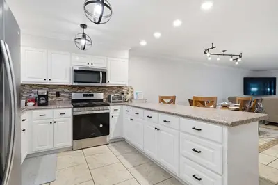 a kitchen with white cabinets and a counter top at 135 Grande Island Blvd in Panama City Beach